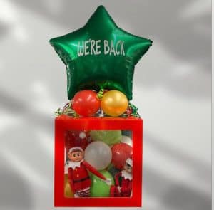 elf on the shelf in a box with balloon