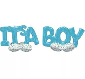 Blue foil balloons spelling It's A Boy with polka dot cushions.