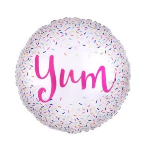 Round foil balloon with colorful sprinkles and 'Yum' text for party decor.