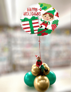 elf on the shelf sitting on balloon cluster with foil balloon