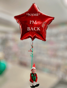 Elf sitting on a balloon with a festive message for Christmas celebrations.